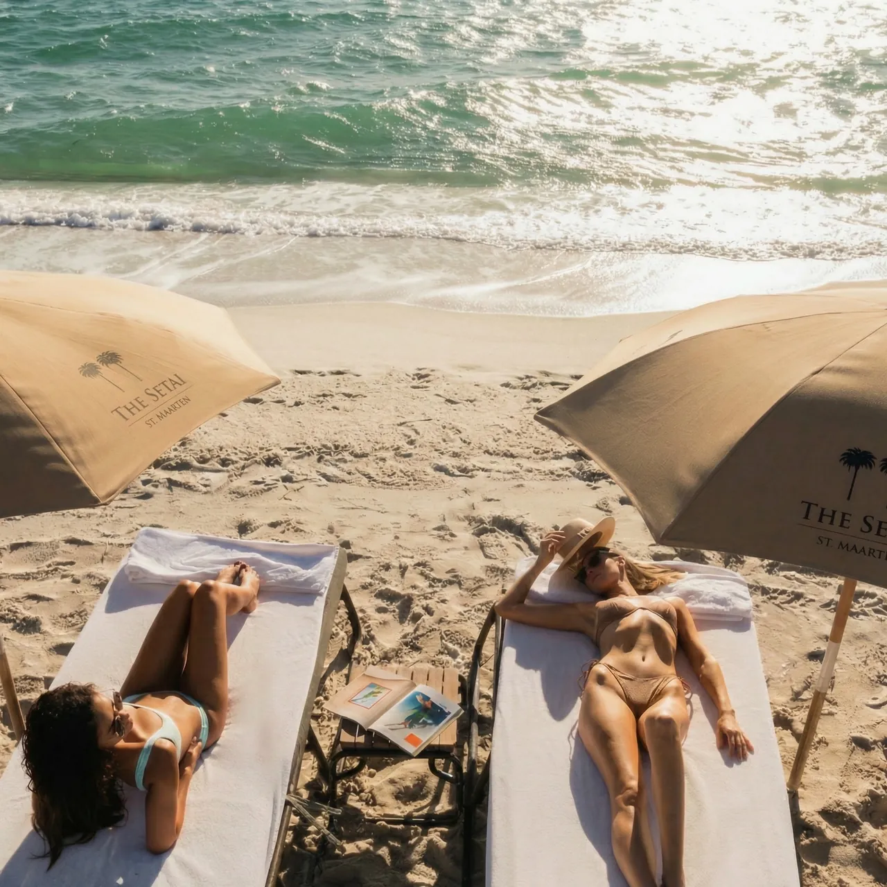 A guest sunbathing on the shore at The Setai, St. Maarten