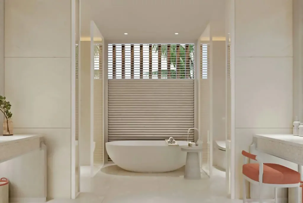 A residence bathroom with a freestanding soaking tub and double vanity at The Setai, St. Maarten
